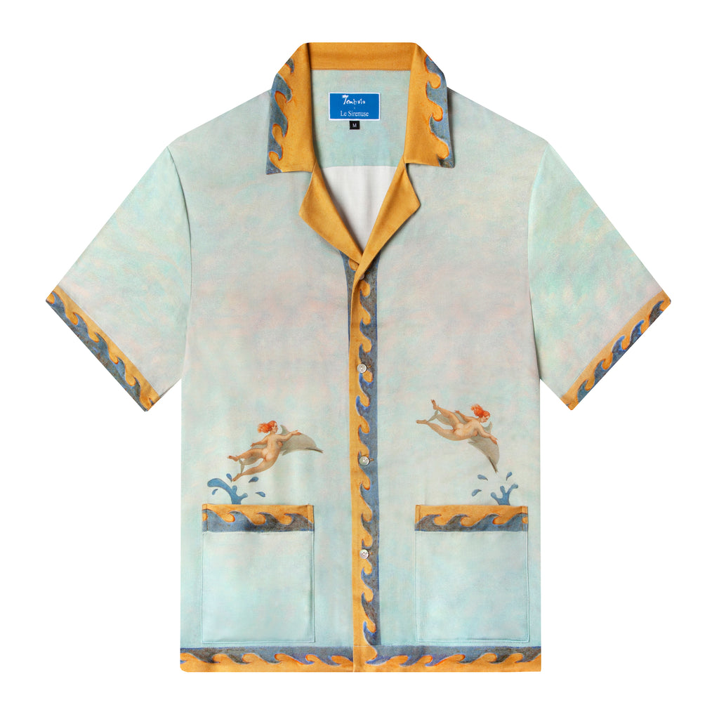 Light blue button up shirt featuring nudes riding dolphins leaping out of the pockets, along with a yellow and blue painted frame design as a border along the bottom sweep, sleeves, placket, and collar