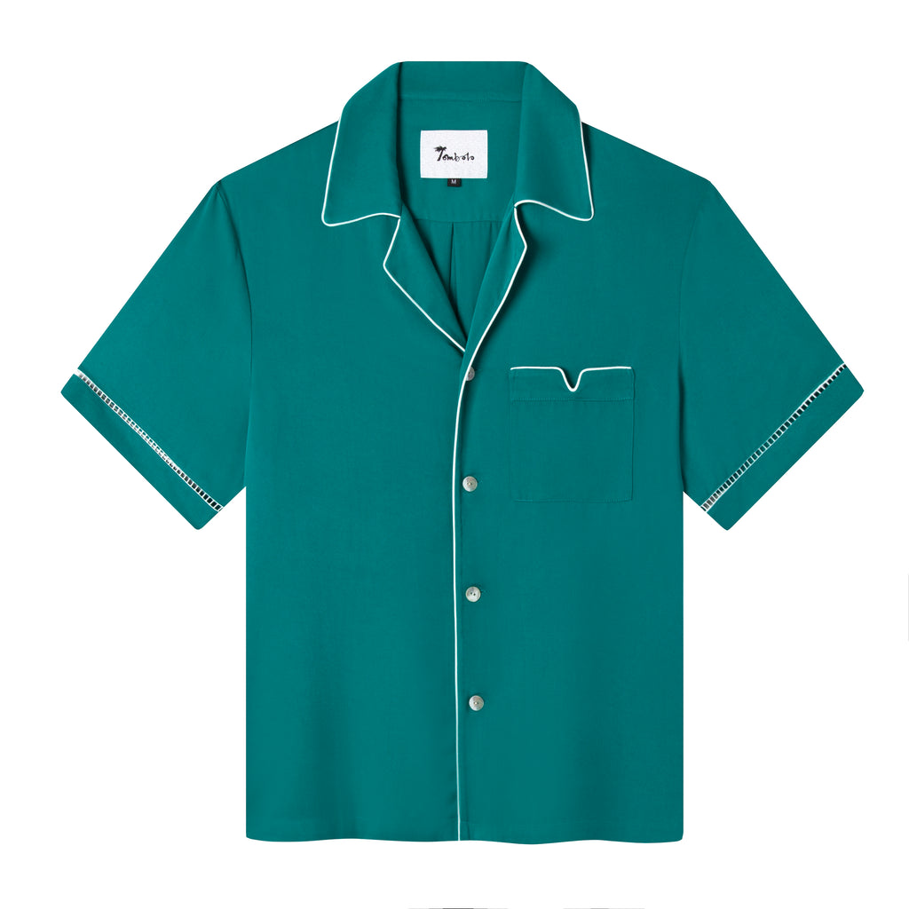 Front view of the teal Cabrisa shirt featuring white window pane embroidery on sleeves and white piping along the pocket and collar with four white buttons down the front