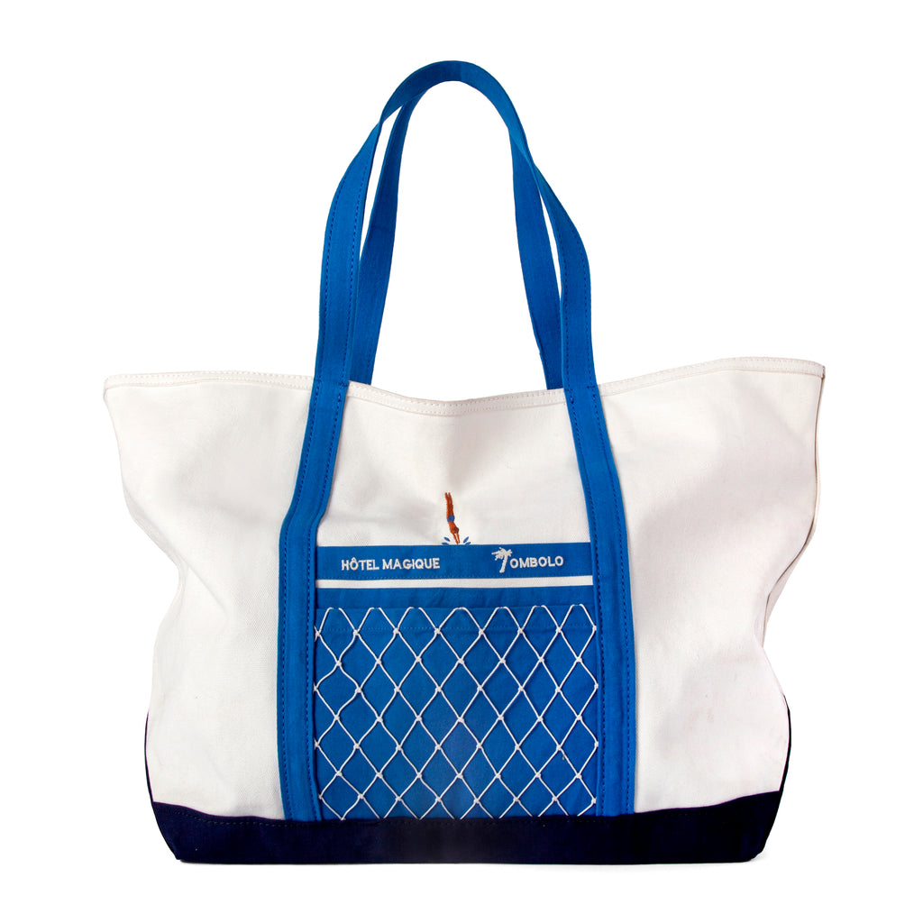 Product photo of the hôtel magique tote bag showing the blue contrasts and navy bottom as well as the appliqued intrepid diver