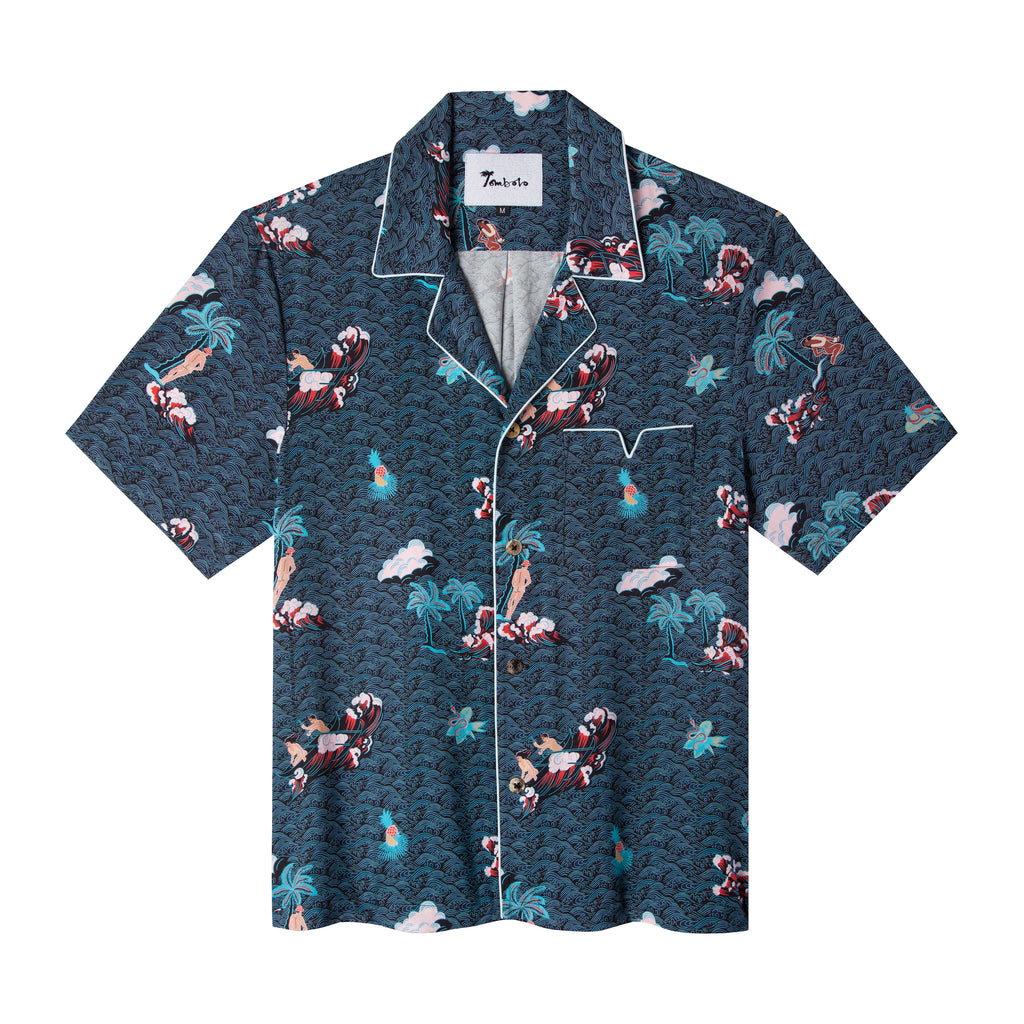 Front lay flat view of shirt with recurring pink Adam and Eve in a tropical garden of Eden print over blue waves with white piping along pocket and collar