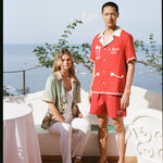 Man and woman in the outdoor dining area of Le Sirenuse wearing the matching finestra set and liguori shirt