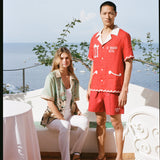Man and woman in the outdoor dining area of Le Sirenuse wearing the matching finestra set and liguori shirt