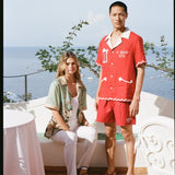 Man and woman pose on the balcony of Le Sirenuse hotel