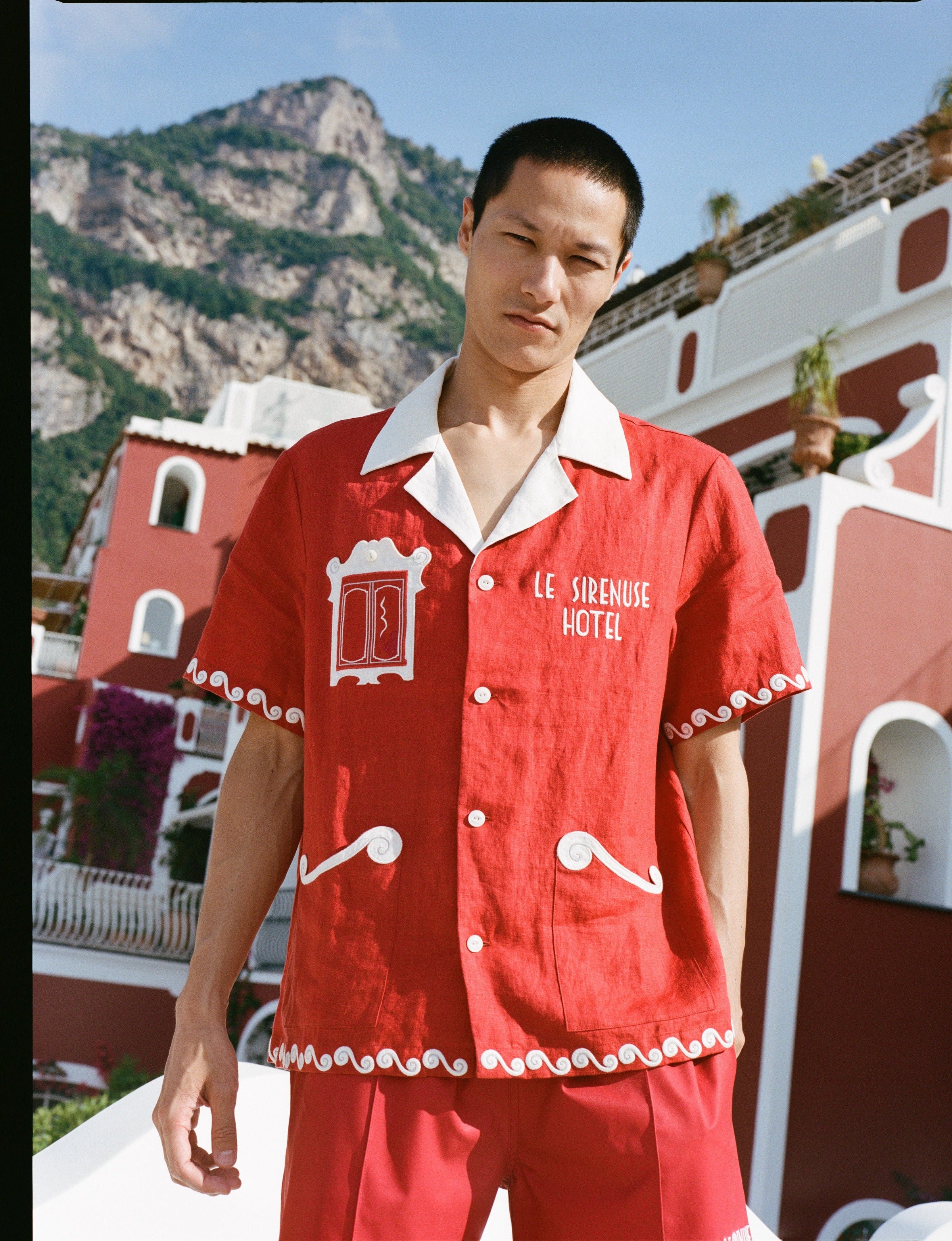 male model in the full matching set in front of buildings
