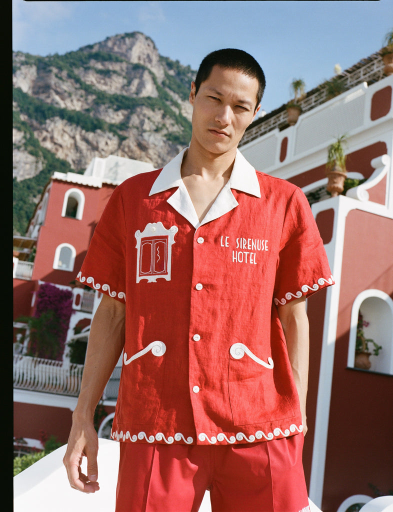 male model in the full matching set in front of buildings