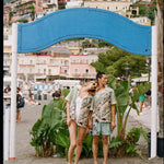 Female model leaning head on male model shoulder both wearing shirt