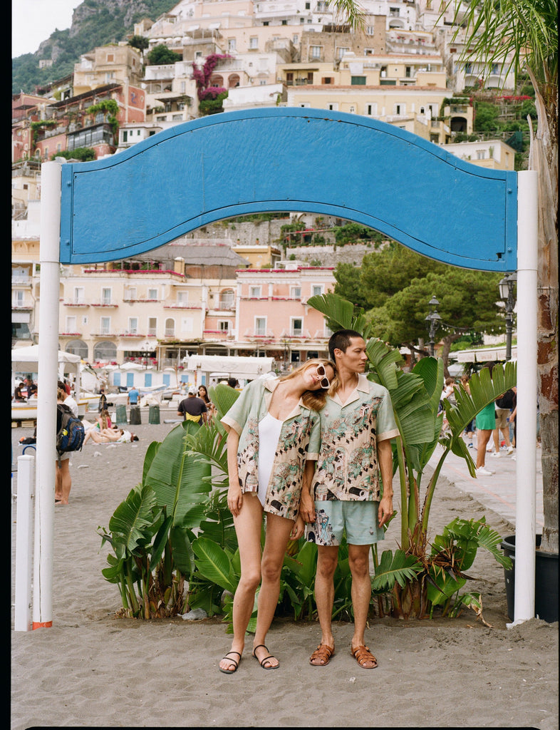 Female model leaning head on male model shoulder both wearing shirt