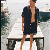 Man standing on dock looking to his right while wearing matching Cabrisa set