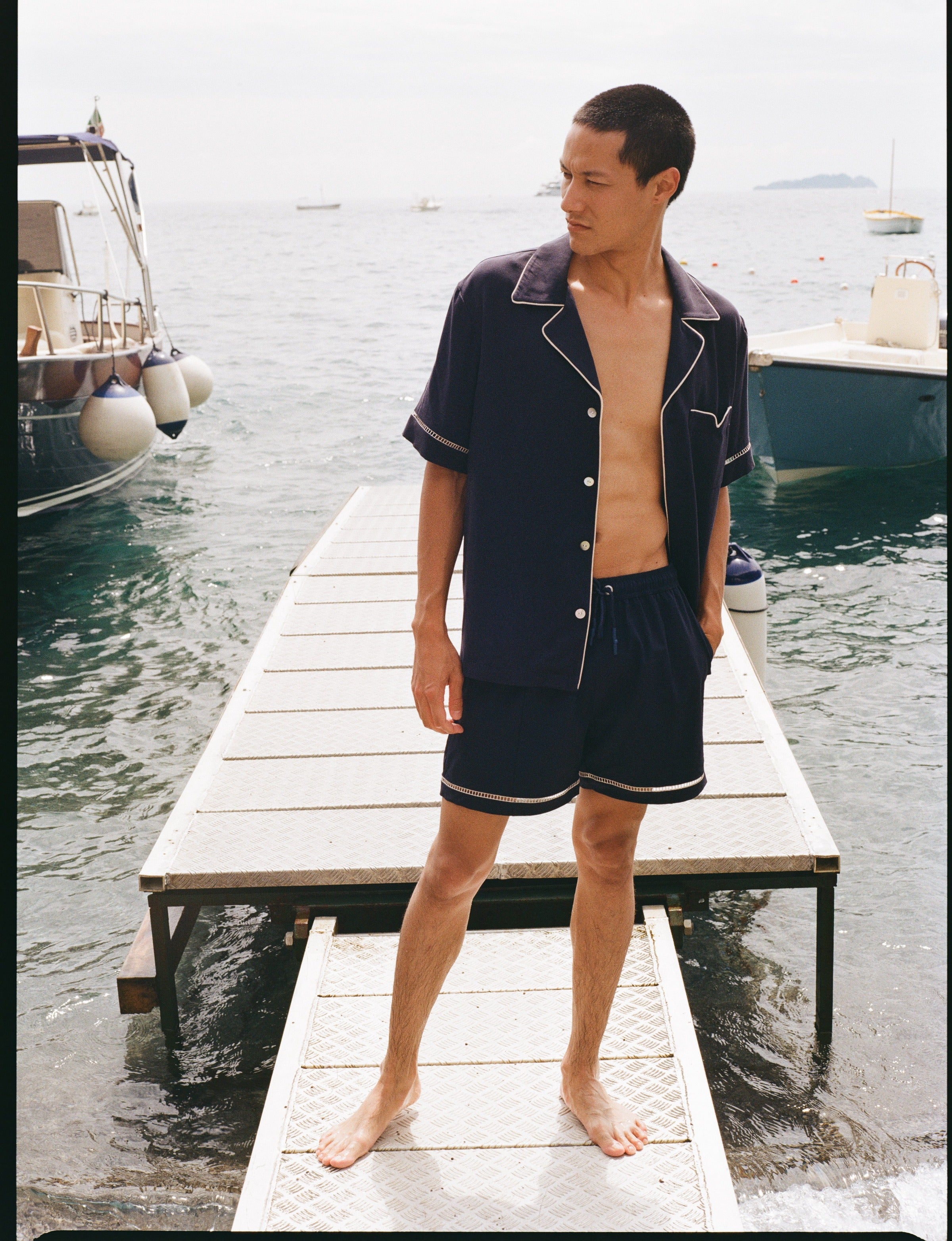 Man standing on dock looking to his right while wearing matching Cabrisa set