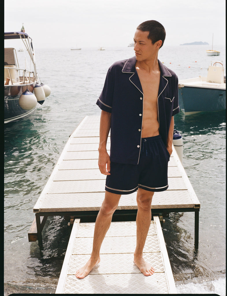 Man standing on dock looking to his right while wearing matching Cabrisa set