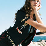 Female model wearing the full vongole set at the beach