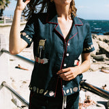 Female model wearing the vongole matching set near the ocean