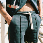Close up of shirt unbuttoned over the matching shorts on a male model outdoors