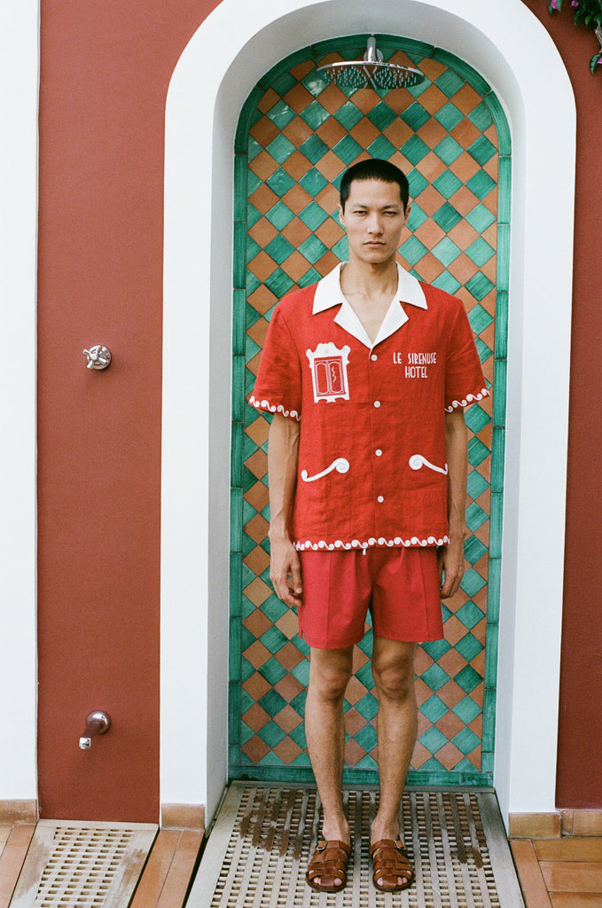 Male model wearing the full set standing in an outdoor shower