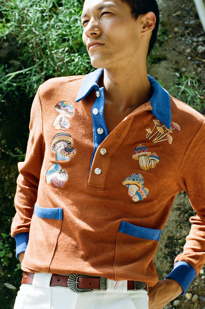 male model looking outwards in cabana with hands in stowaway shorts pockets