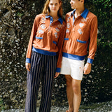 female model donning cabana with navy easy going pants and male model in cabana and white stowaway shorts