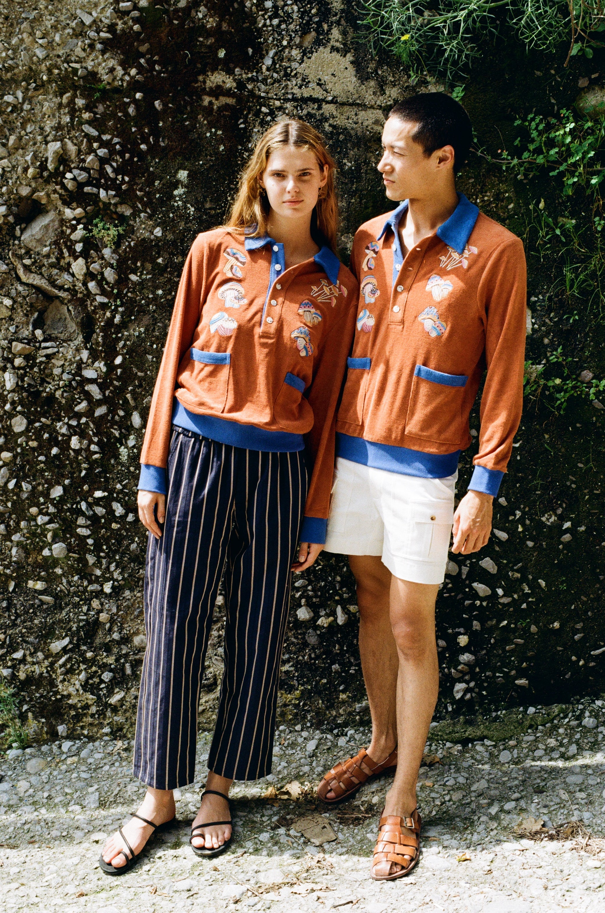 female model donning cabana with navy easy going pants and male model in cabana and white stowaway shorts