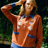 female model posing in disco fungi cabana with hands in her hair
