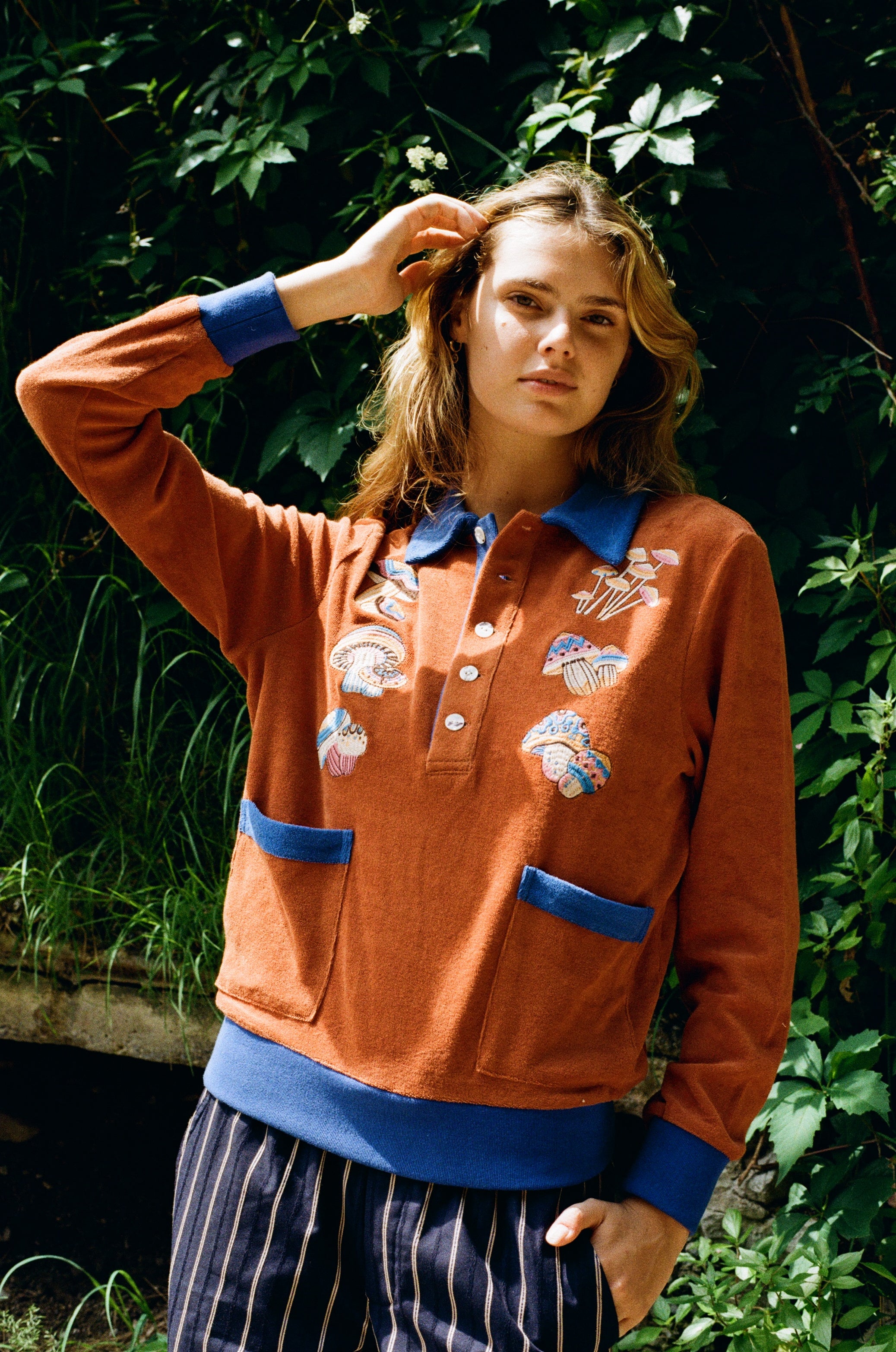 female model posing in disco fungi cabana with hands in her hair