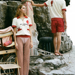 woman looks off into the distance while Man turns his back on the camera