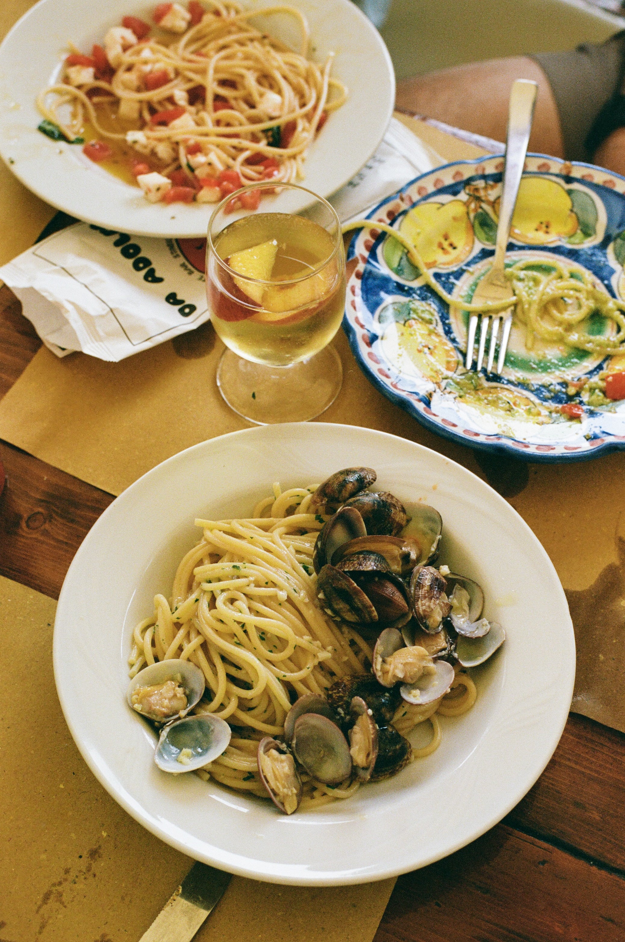 Close up of food from Da Adolfo restaurant, a plate of spaghetti alle vongole and a pomodoro pasta
