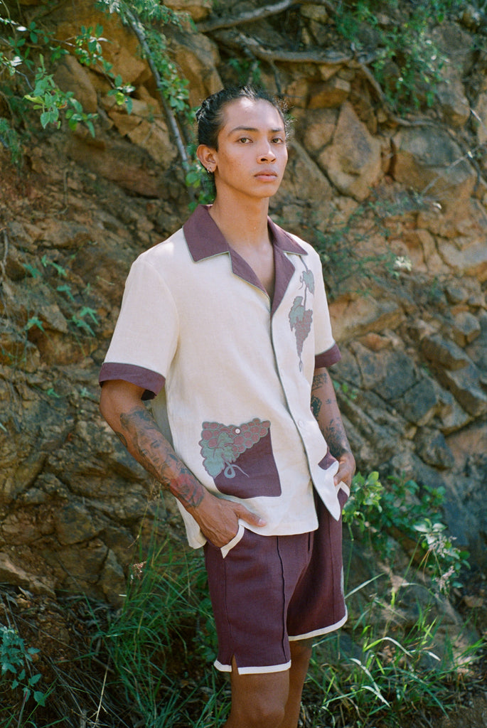 Male model standing against wall with vines wearing full 'Tombarolo' cabana set