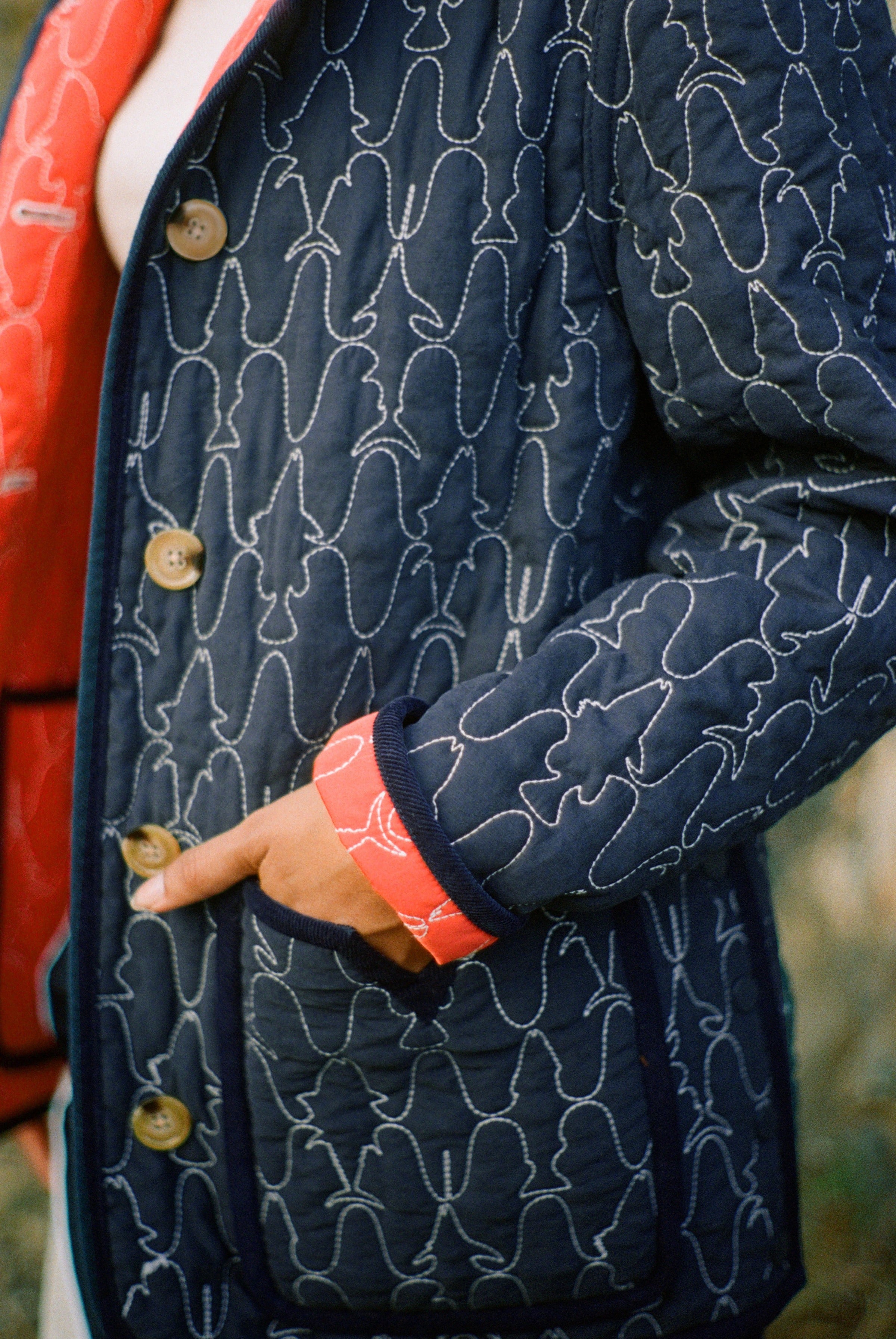 Hand inside pocket of quilted jacket