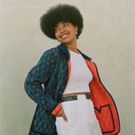 Woman looks off camera wearing reversible jacket