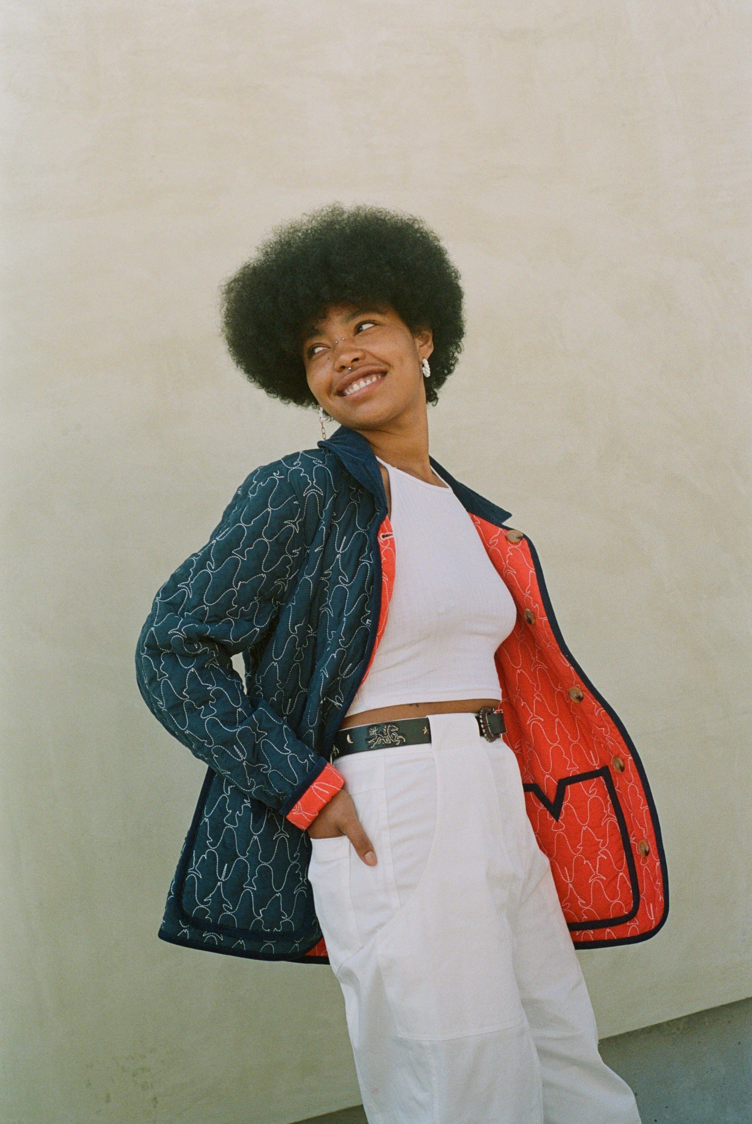 Woman looks off camera wearing reversible jacket