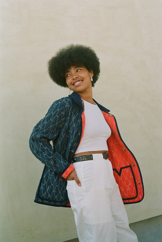 Woman looks off camera wearing reversible jacket