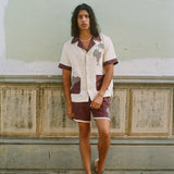 Man leaning against wall in full 'Tombarolo' cabana set.
