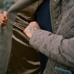 Man touches interior lining of jacket