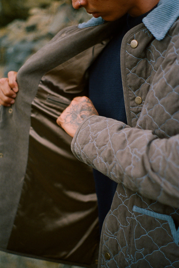 Man touches interior lining of jacket