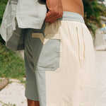 close up of back side of shorts as man holds up the waist 
