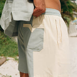 close up of back side of shorts as man holds up the waist 