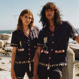 Male and female models on the beach wearing the full matching set