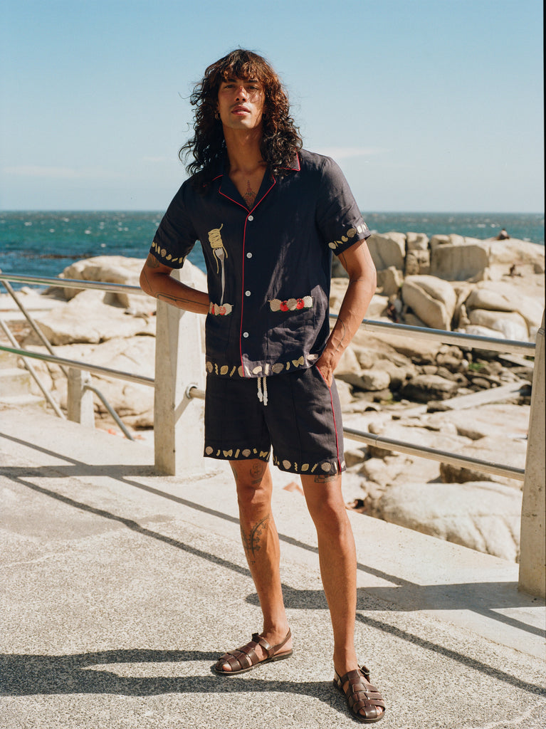 Male model on beach wearing vongole cabana with matching shorts