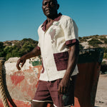 Man in full Tombarolo cabana set leaning against dry docked boat
