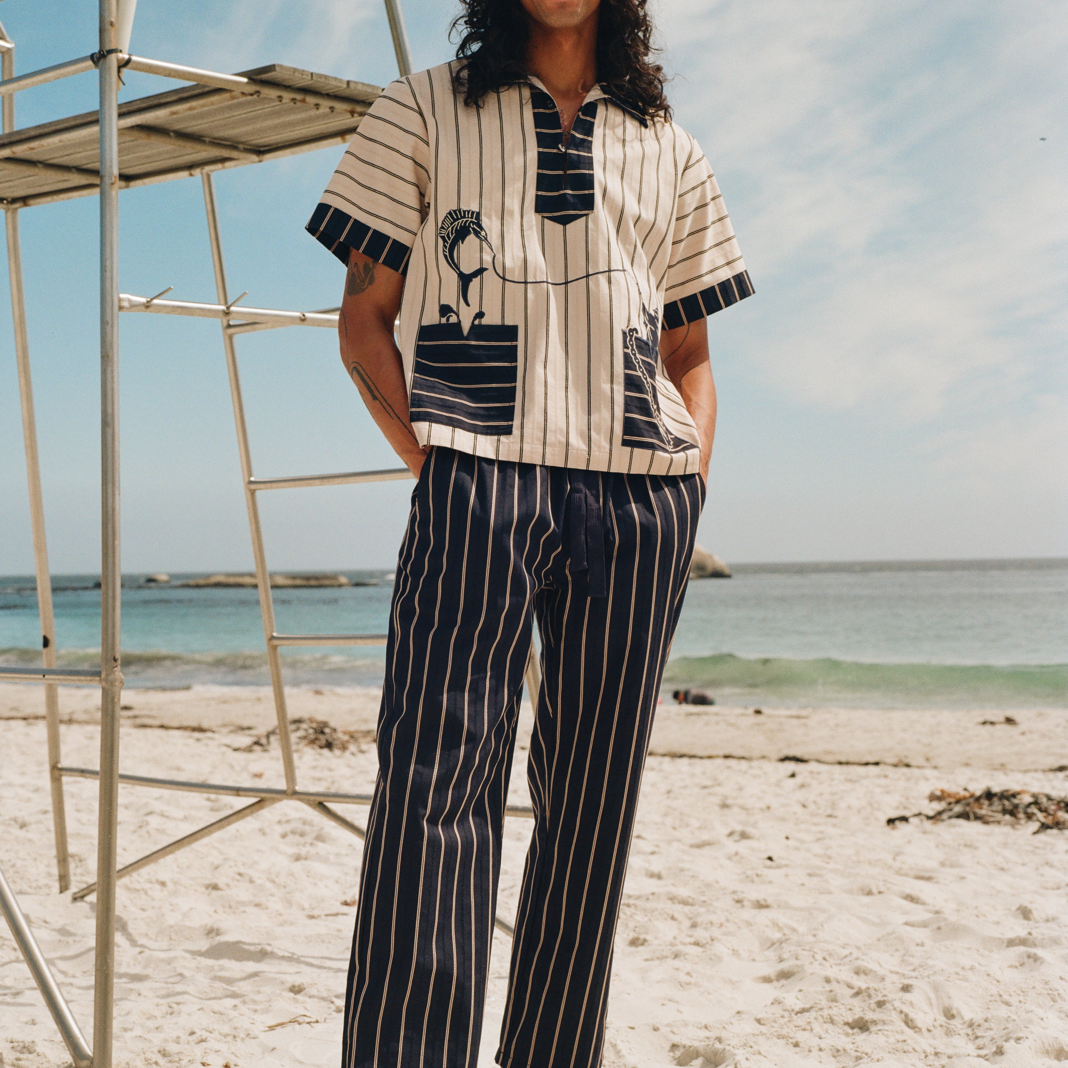 Man on beach wearing navy version of Easy going pants