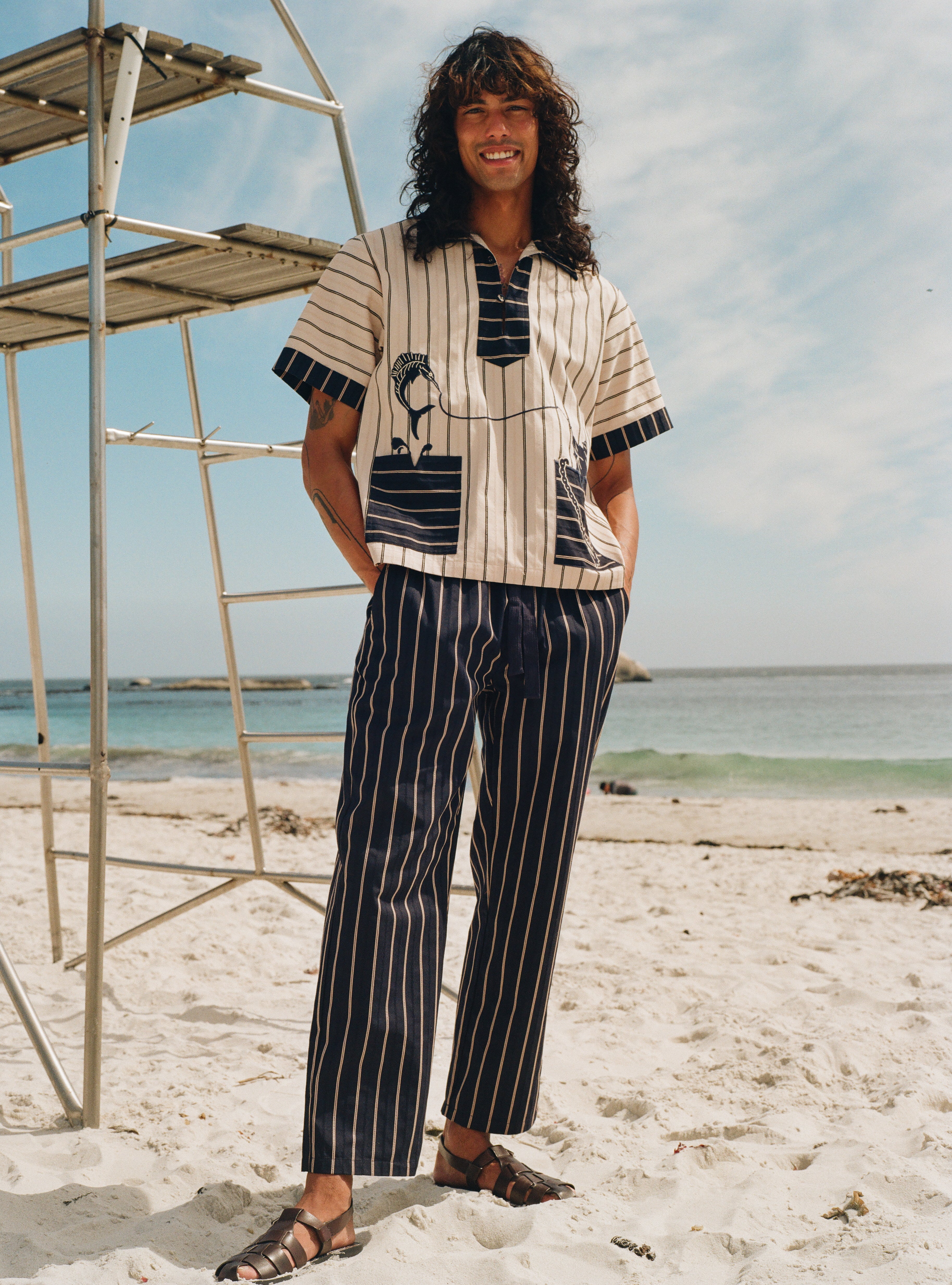 Man on beach wearing navy version of Easy going pants