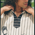 Close up of male model looking to the right, wearing Tombolo striped pop-over shirt