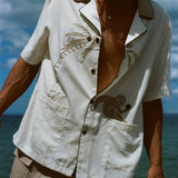 Closer image of male model at the beach, wearing his 'Monkey Business' Shirt slightly unbuttoned. 