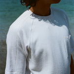 Cropped image of a man wearing the terry tee and looking off to the side.