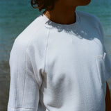 Cropped image of a man wearing the terry tee and looking off to the side.