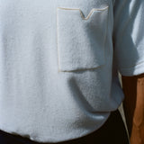 Close up image of the terry cloth fabric and the front pocket, featuring a v-notch. 
