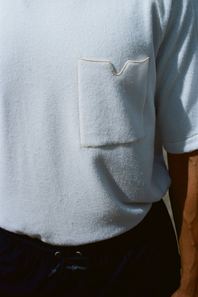 Close up image of the terry cloth fabric and the front pocket, featuring a v-notch. 