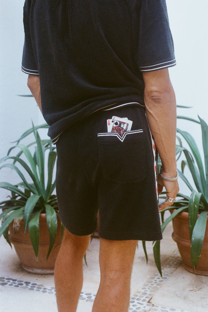 Close-up shot behind a man wearing the 'Vicey Dicey' Shorts, with his hip popped to the right.