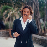Man wearing the Easy-Going Tuxedo Jacket fully buttoned, and twisting the end of his mustache.