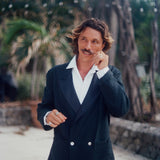 Man wearing the Easy-Going Tuxedo Jacket fully buttoned, and twisting the end of his mustache.