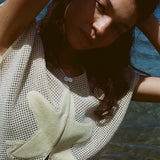 Close-up image of brunette female model posing with her arms above her head in the 'Starfish Strut' Hand Towel Top.
